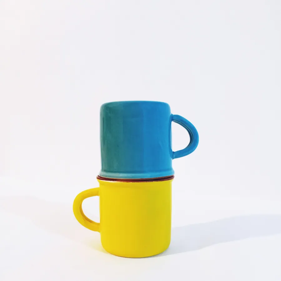 Two stacked mugs, small in the frame